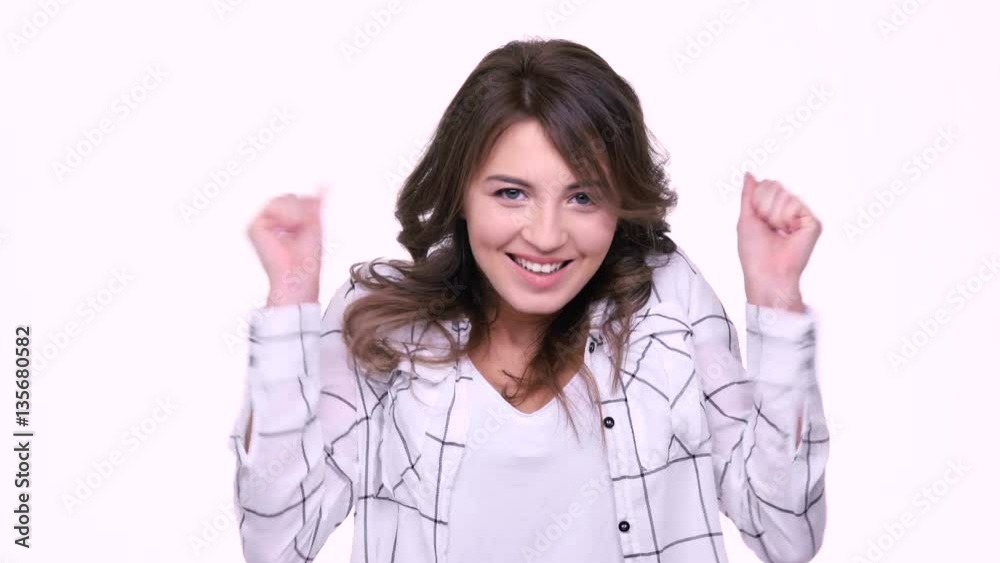 Beautiful young smiling woman hearing good news while standing isolated on white Beautiful young smiling woman hearing good news while standing isolated on white
