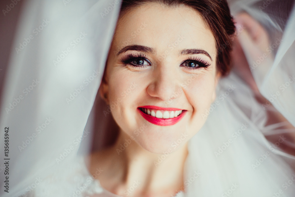 The smilling bride stands in the center of room The smilling bride stands in the center of room