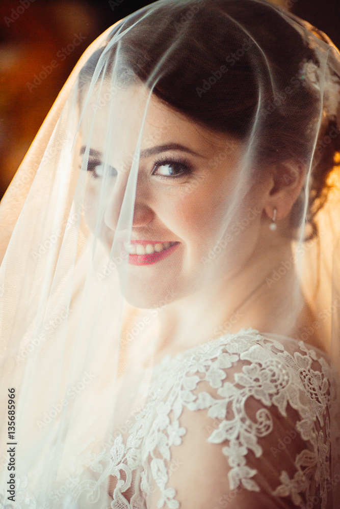 The smilling bride stands in the center of room The smilling bride stands in the center of room