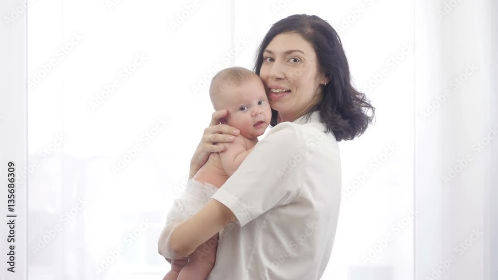 Happy Mother and Baby. Portrait of a beautiful young mother with a child in her arms.
