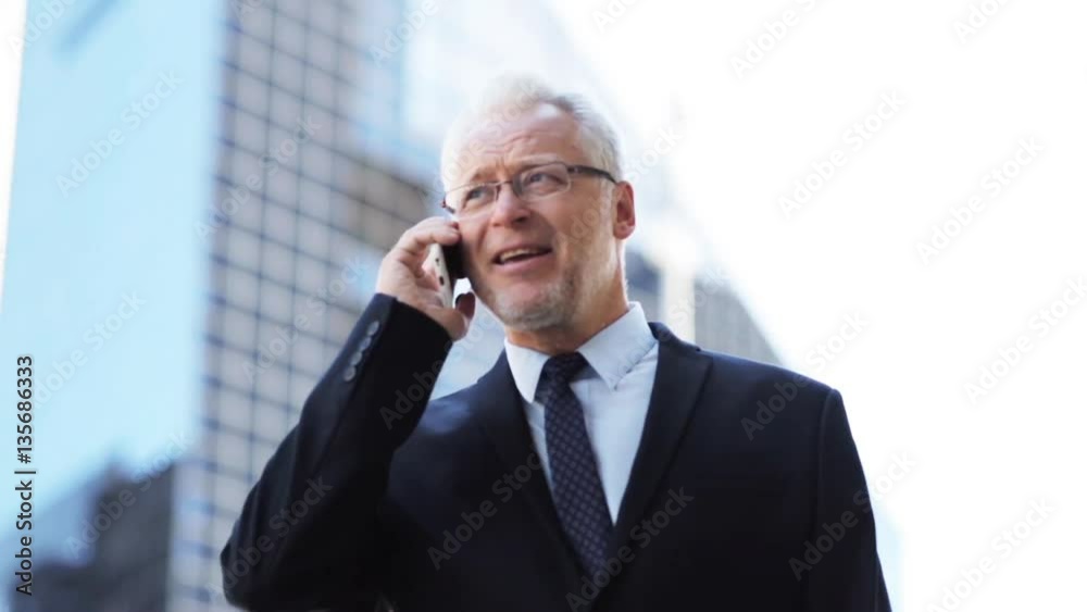 senior businessman calling on smartphone in city senior businessman calling on smartphone in city