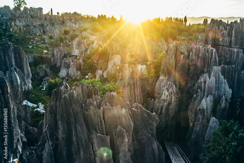 Colorful sunset in Stone Forest in Shilin, Yunnan Province, South China, not far from the  Kunming. It is the world-famous natural area of limestone formations and UNESCO World Heritage Site.