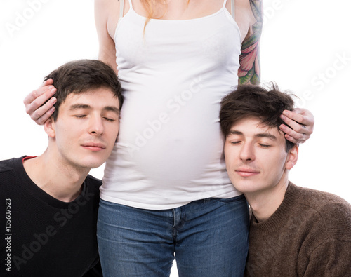 Young pregnant woman posing with two young man