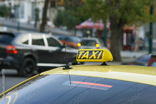 Yellow cab with taxi sign on roof