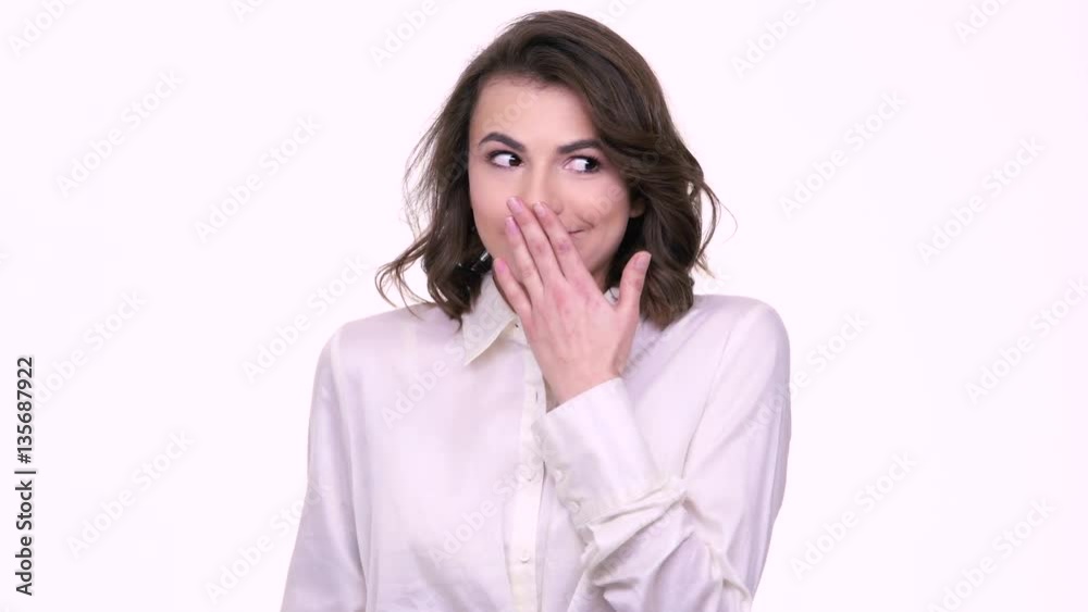 Puzzled embarrassed girl with mobile phone isolated over white Puzzled embarrassed girl with mobile phone isolated over white