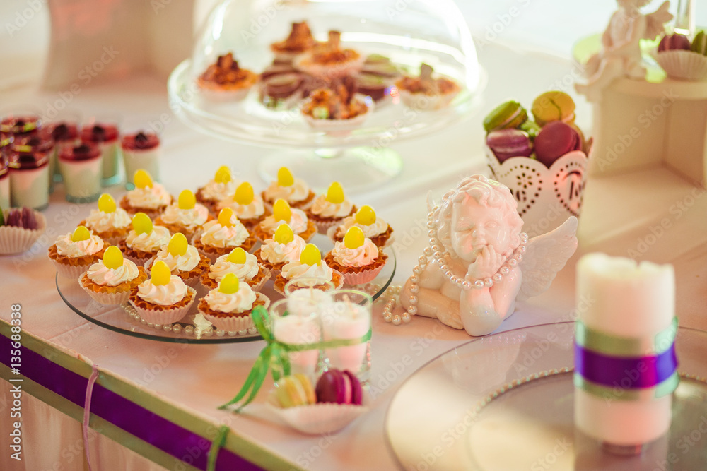 The sweety cakes stand on the buffet table