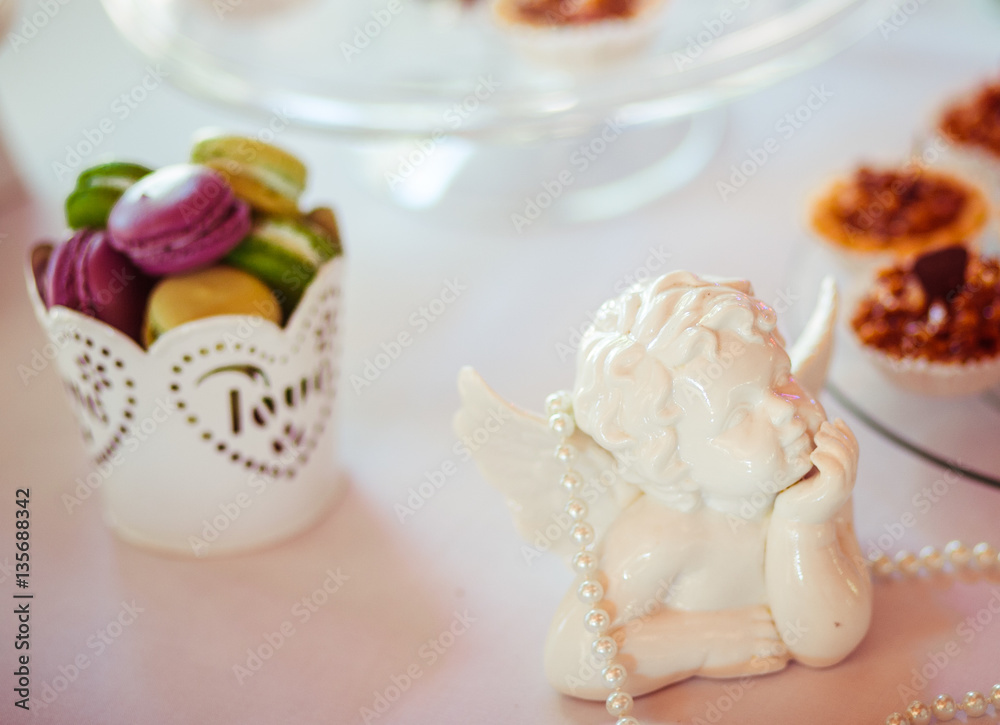 The sweety macaroons stand on the buffet table The sweety macaroons stand on the buffet table