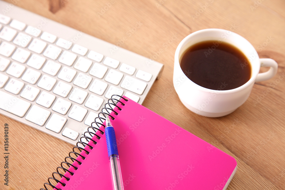 on the desktop computer and a cup of coffee