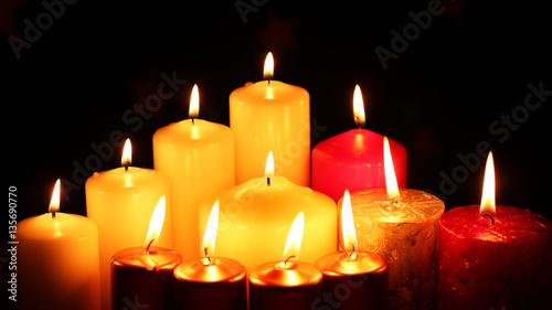lot multicolored candles lit darkness