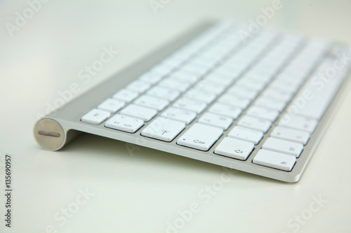 stylish aluminum keyboard lies on a white table