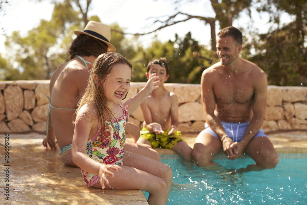 Fototapeta premium Family On Vacation Having Fun By Outdoor Pool