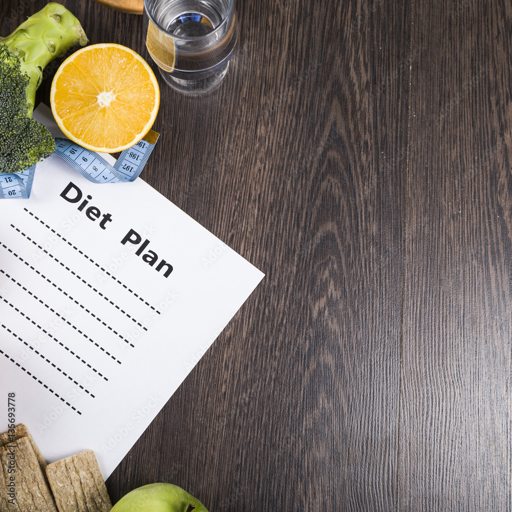 custom made wallpaper toronto digitalFood and sheet of paper with a diet plan on a dark wooden table.