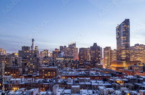 Snowy rooftops and mIdtown Manhattan at dusk, seen from 72nd street on the Upper West Side, New York.