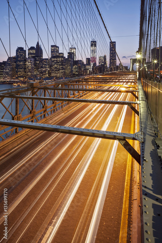 Traffic leaves colourful trails along the Brooklyn Bridge in New York, New York State, USA.