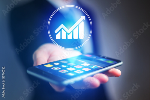 Businessman hand holding mobile phone with chart icon