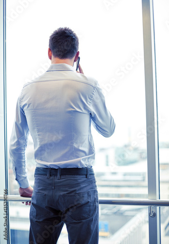 businessman calling on smartphone in office