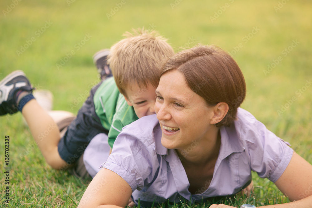 Fototapeta premium happy blond caucasian kid outdoor family portrait at park with his mum 
