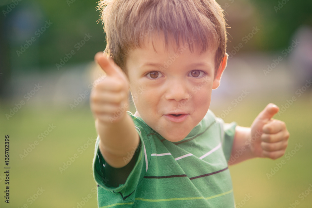 happy smiling blond caucasian kid outdoor portrait at park happy smiling blond caucasian kid outdoor portrait at park