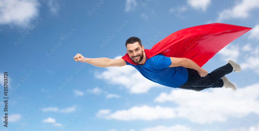 happy man in red superhero cape flying over sky happy man in red superhero cape flying over sky
