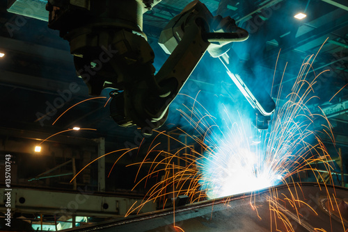 Sparks and smoke from robot welding in used manufacturing