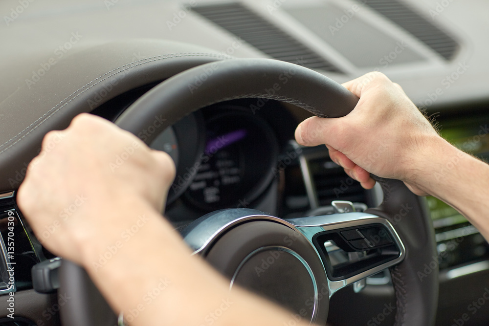 close up of male hands driving car