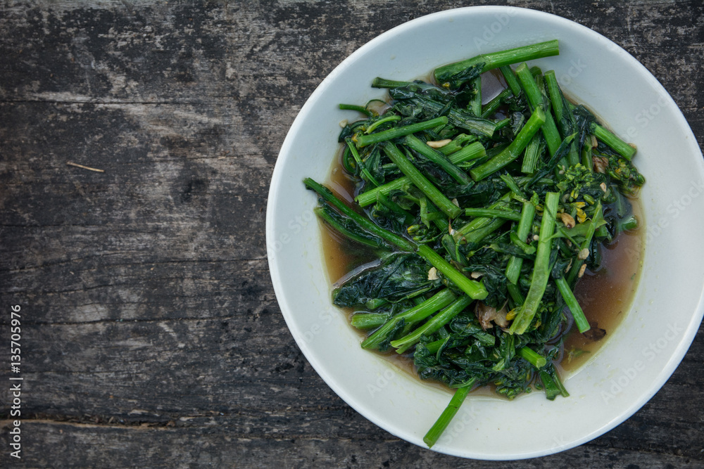 stir fried morning glory. phad puk boong fri dang. thai food on wooden background stir fried morning glory. phad puk boong fri dang. thai food on wooden background