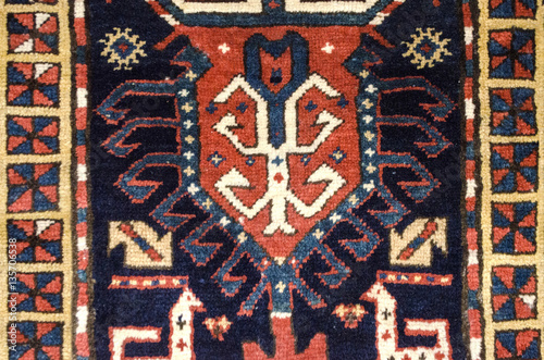 Edges and central part with ethnic ornament on eastern woolen carpet