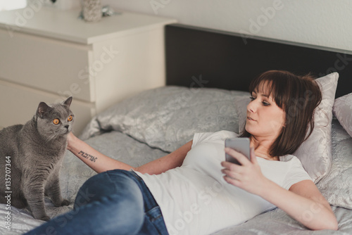 beautiful girl with a cat in bedroom