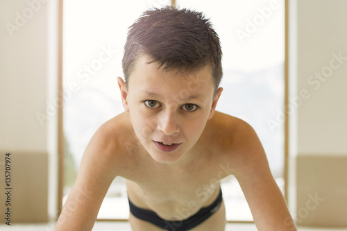 Portrait of Smiling Teen Boy in a Swimming Pool With Copy Space