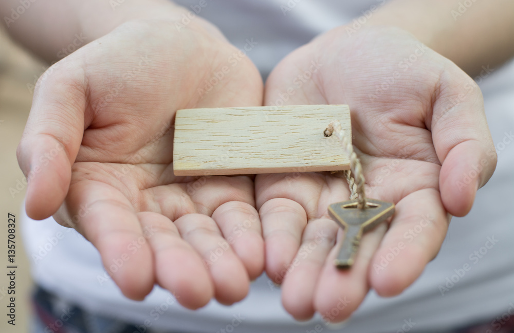 Fototapeta premium Old key vintage in woman hand with tag.Business concept .
