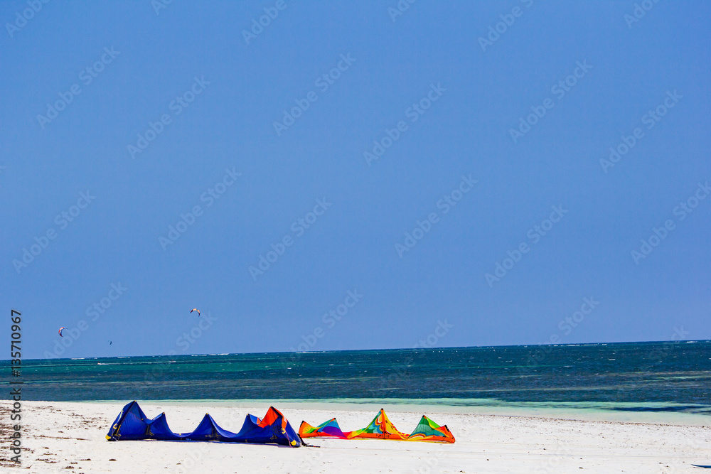 Two kitesurf parachute lying on the white beach Two kitesurf parachute lying on the white beach