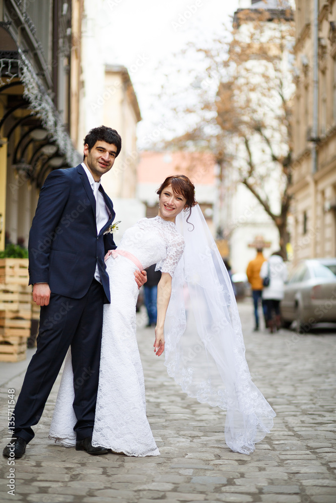 bride and groom posing on the streets of the old city
