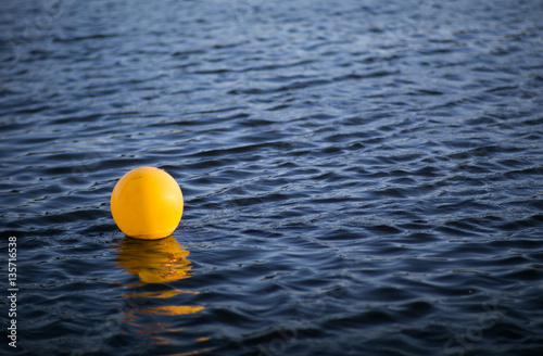 Yellow signal buoy in lake water © Pornpen