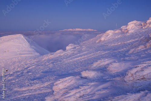 Amazing foggy sunset at mountain peak during cold winter day in Mala Fatra, Slovakia