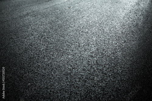 Dark asphalt roadbed.