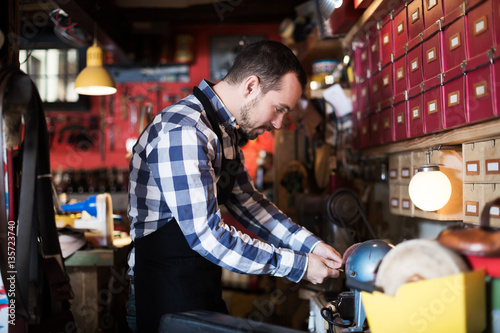 Worker preparing buckle for belt