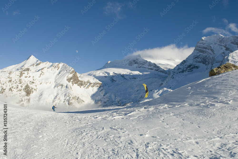 skier makes snowkiting with a panorama of snowy mountains, Swiss Alps skier makes snowkiting with a panorama of snowy mountains, Swiss Alps