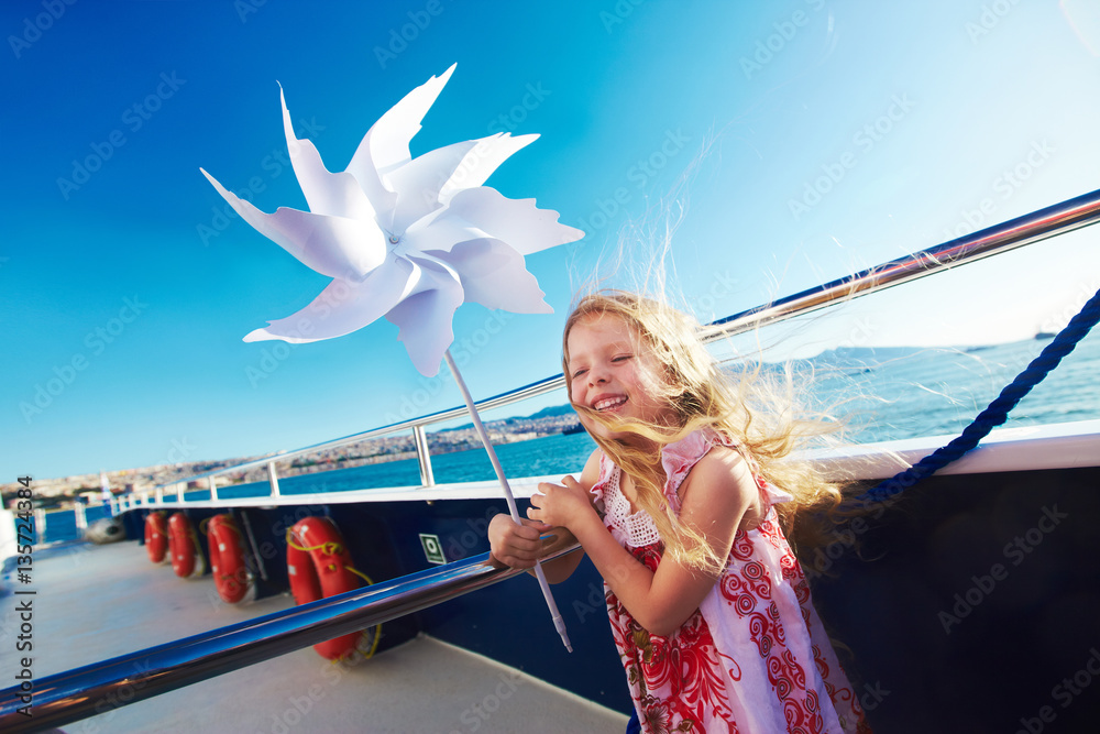 custom made wallpaper toronto digitalCute blonde small girl playing with pinwheel on cruise ship deck, sunny weather