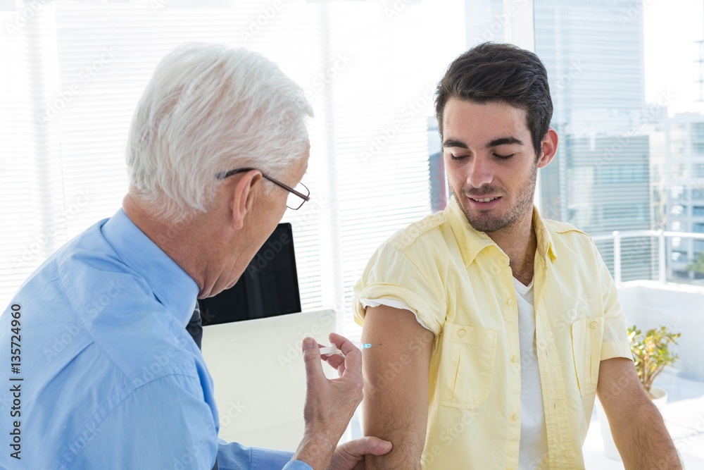 Doctor giving an injection to the patient Doctor giving an injection to the patient