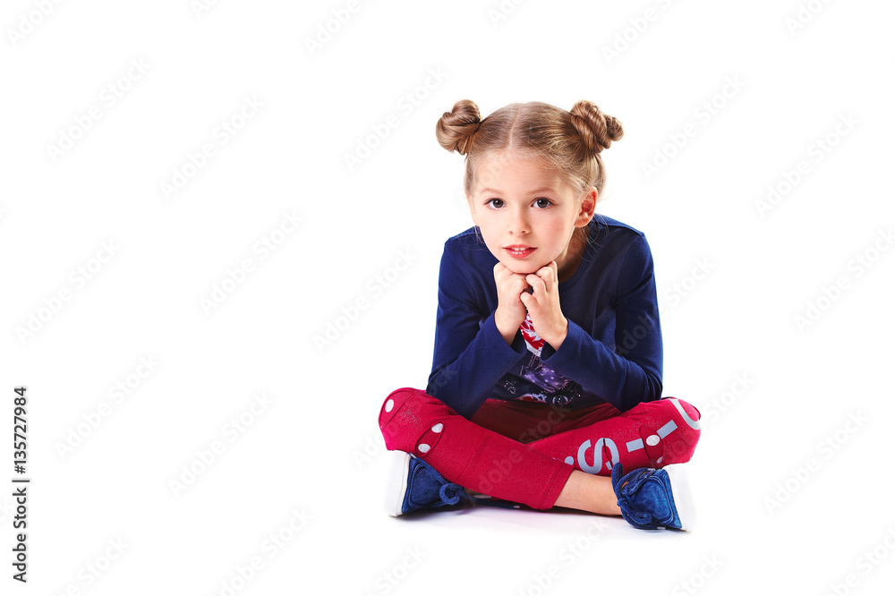 Pretty blondie six years old small girl on white background sitting Pretty blondie six years old small girl on white background sitting
