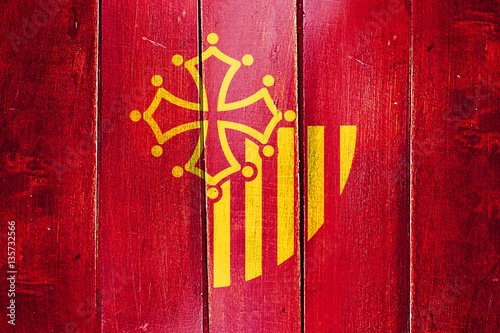 Vintage Languedoc rousillon flag on grunge wooden panel photo