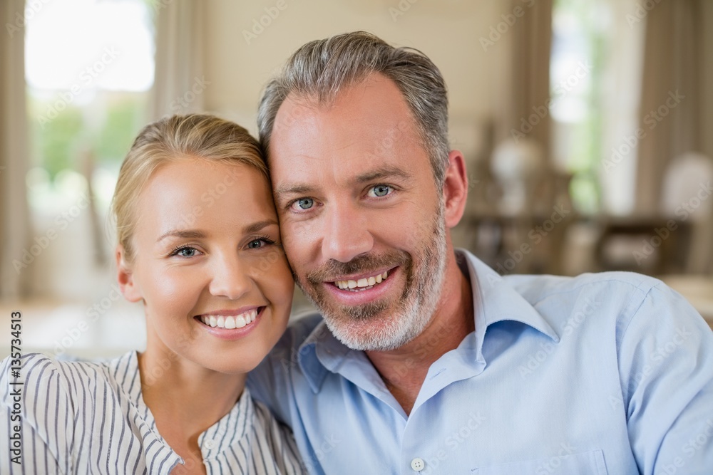Romantic couple smiling in living room Romantic couple smiling in living room