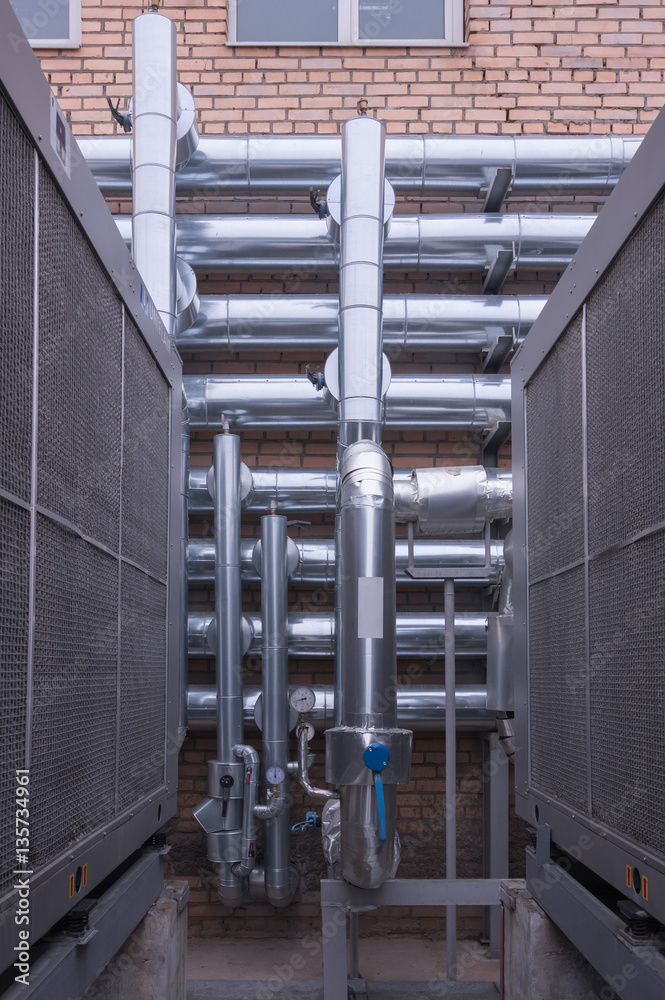 Naklejka premium Technological pipework made of shining steely pipes