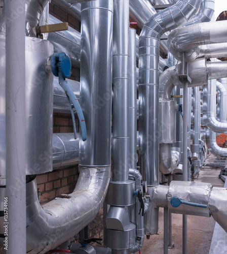 Canvas Print Technological pipework made of shining steely pipes