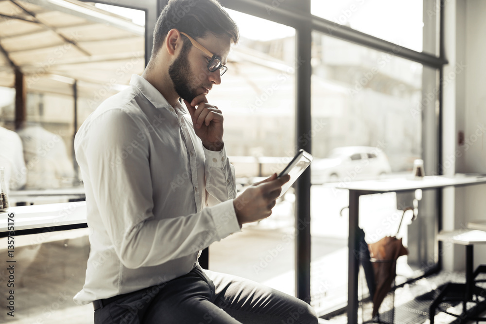 Businessman wearing glasses using tablet Businessman wearing glasses using tablet