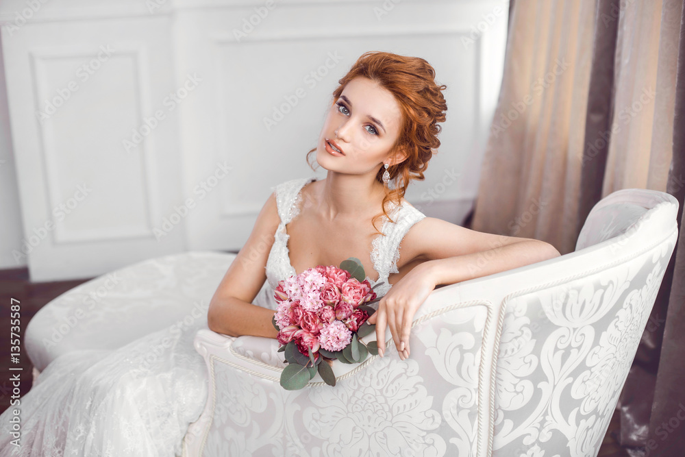 Bride in beautiful dress sitting resting on sofa indoors Bride in beautiful dress sitting resting on sofa indoors