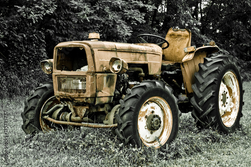 Rusty tractor abandoned in a field