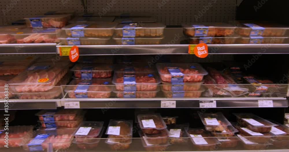 Grocery shopping in the meat department of a big supermarket