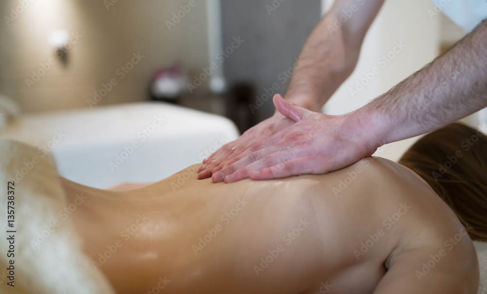 Fototapeta premium Masseur massaging back of female