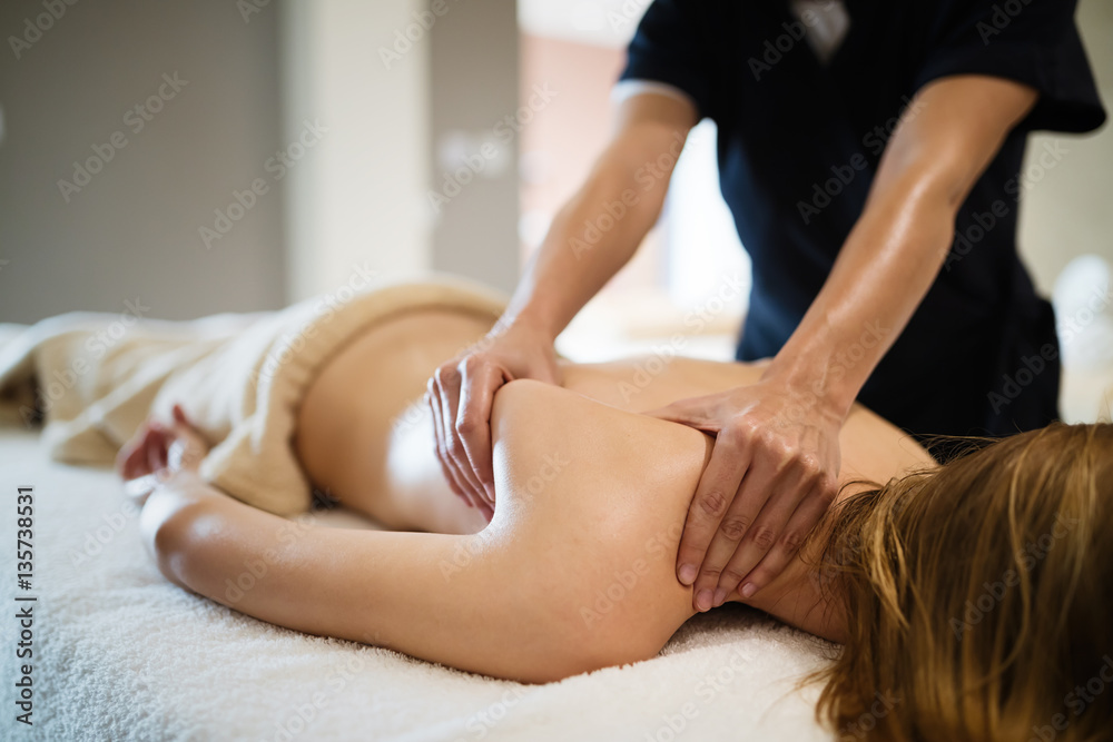 Fototapeta premium Masseur massaging female client at resort